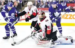  ?? FRANK GUNN / THE CANADIAN PRESS ?? Ottawa goalie Craig Anderson clears the puck from the front of the net in Wednesday night’s win over the Leafs.