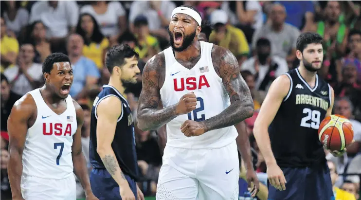  ?? — GETTY IMAGES ?? United States big man DeMarcus Cousins, centre, and guard Kyle Lowry get pumped up by a raucous crowd during their quarter-final victory over Argentina.