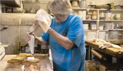  ?? ASHLEE REZIN GARCIA/SUN-TIMES PHOTOS ?? Sandy Budz, whose brother owns Bridgeport Bakery, makes pastries on Friday.