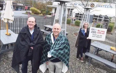  ?? Arnold Gold / Hearst Connecticu­t Media ?? From left, Gerry Barker, Rob Kauffman, co-owner of The Stand, and server Keya Recchia stand in the outdoor dining area of The Stand in Branford on Friday, to promote the “Bring Your Own Blanket” campaign for outdoor dining in the colder months ahead. Below, a “Bring Your Own Blanket” sign in front of The Stand.