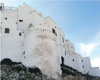  ??  ?? The whitewashe­d walled city of Ostuni is perched on a hill above olive groves.