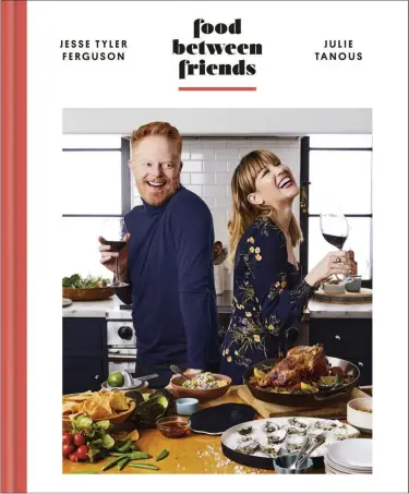  ?? CLARKSON POTTER VIA THE ASSOCIATED PRESS ?? The cover of “Food Between Friends” by Jesse Tyler Ferguson and Julie Tanous.