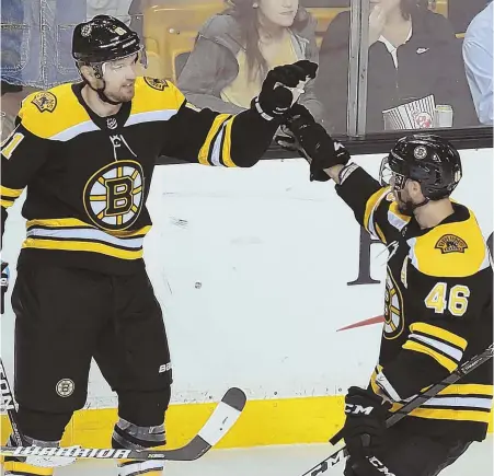  ?? STAFF PHOTO BY JOHN WILCOX ?? HOT START: Rick Nash celebrates with David Krejci after scoring in the first period of the Bruins' 4-3 overtime win against the Hurricanes last night at the Garden.