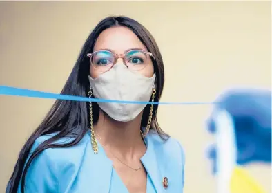 ?? TOM WILLIAMS/GETTY ?? Alexandria Ocasio-Cortez, D-N.Y., arrives for a hearing before the House Oversight and Reform Committee on Aug. 24 in Washington, D.C. The 31-year-old has received a COVID-19 vaccine and that has sparked criticism.