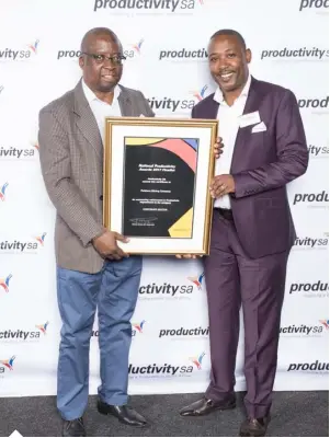  ??  ?? General Manager for Asset Management and SHEQ, Mr Zakes Malepe and the General Manager for Marketing and Logistics, Keith Mathole receiving an award for Energy Management Programme at the national Productivi­ty Awards