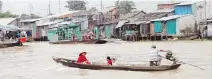  ??  ?? Most traffic on the Mekong River is still small boats. Below left, selling rat meat at the market in Sa Dec; below right, as our group came into Vihn Hoa, everyone came out of riverfront houses, built on stilts, to say hello.