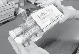  ?? Rich Pedroncell­i / Associated Press file ?? Most parents of children with severe allergies buy EpiPens for home, in the car and school and may replace them every year, depending on the expiration date.