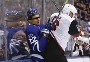  ?? BERNARD WEIL, TORONTO STAR ?? Leafs defenceman Nikita Zaitsev (22) is slammed into the boards by Coyotes’ Max Domi, who got an empty-net goal.