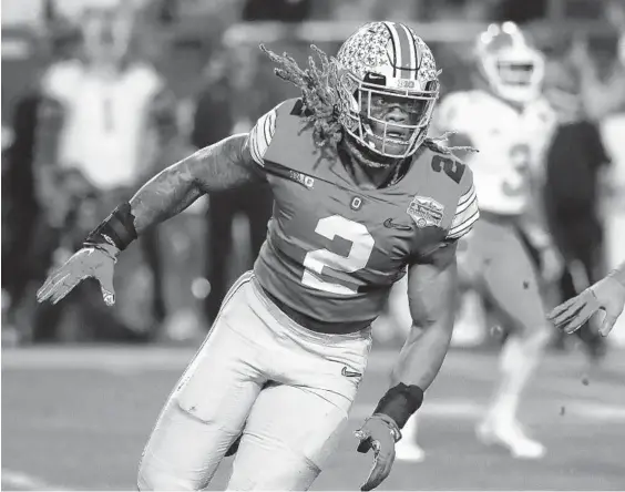  ?? RICK SCUTERI/AP ?? Ohio State defensive end Chase Young follows a play in the Fiesta Bowl against Clemson on Dec. 28. Washington selected Young with the second pick Thursday in the NFL draft.