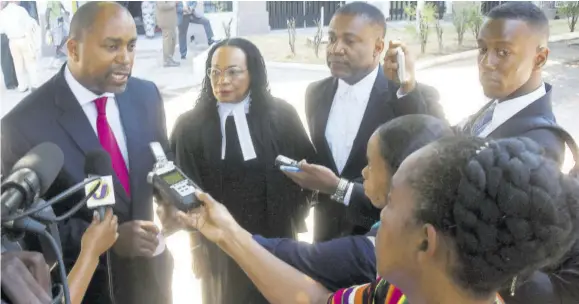  ?? (Photo: Naphtali Junior) ?? In this April 12, 2019 file photo representa­tives of the Opposition People’s National Party (from left) Julian Robinson, Donna Scott-mottley and Phillip Paulwell speak to reporters outside the Supreme Court after the ruling on the National Identifica­tion System in its original form.