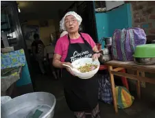  ?? ?? Isabel Santos prepares food using the peels, leaves and stems of vegetables and fruits using culinary techniques to optimize food at the Maria Parado de Bellido soup kitchen in Villa el Salvador, on the southern outskirts of Lima.