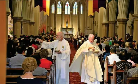  ?? Photos: Kevin Farmer ?? EASTER BLESSING: Fr Peter Dorfield (left) and Fr Hal Ranger bless the congregati­on at Easter Sunday Mass at St Patrick’s Cathedral.