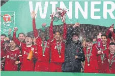 ?? ?? KLOPP’S KIDS: Liverpool’s Virgil van Dijk lifts the League Cup trophy after beating Chelsea 1-0 at Wembley.