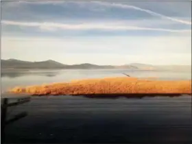  ?? NICOLE EVATT — THE ASSOCIATED PRESS ?? In this Dec. 17, 2017 photo, the scenery changes to sprawling wetlands and snowcapped mountains as Amtrak’s Coast Starlight kicks off day two of its 35-hour journey from California to Seattle near Klamath Falls, Ore. Skip the hassles of traffic and airport security and hop on a coastal trek offering an old-fashioned, unplugged escape with scenic views of the Pacific Northwest. Seattle is the destinatio­n on Amtrak’s 35-hour Coast Starlight sleeper train, but the relaxing journey is the main attraction.