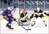  ?? Adam Hunger / Associated Press ?? Bruins defenseman Jeremy Lauzon, right, defends against Islanders right wing Jordan Eberle in front of Bruins goaltender Tuukka Rask on Saturday.