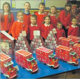  ??  ?? Pirnmill Primary pupils with the advent calenders gifted by Pirnmill Stores. See letter below.