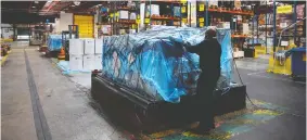  ?? THOMAS COEX / AFP VIA GETTY IMAGES ?? Cargo is prepared for loading onto an Air France plane in Roissy airport, near Paris, on Wednesday, as focus increases on the transport and storage of COVID vaccines.