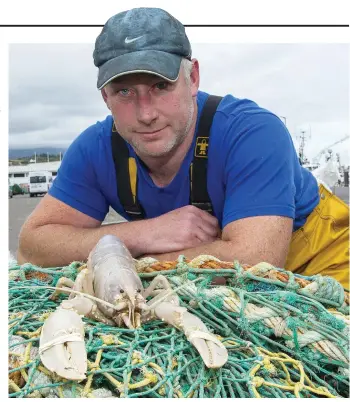  ?? Photo: Niall Duffy ?? Donagh O’Connor with a rare female white lobster caught off Mizen Head, Cork.