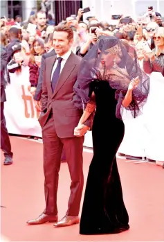  ??  ?? Bradley Cooper (left) and Lady Gaga attend the ‘A Star Is Born’ premiere during 2018 Toronto Internatio­nal Film Festival at Roy Thomson Hall on Monday in Toronto, Canada.