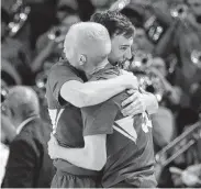  ??  ?? BYU guard Evan Troy, left, hugs Haws after Haws’ last-second basket.