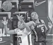  ?? RONALD CORTES AP ?? Northweste­rn forward Paige Mott, left, battles for possession with UCF forward Masseny Kaba.