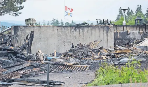  ?? LAURA JEAN GRANT/CAPE BRETON POST ?? Nothing but charred debris remained of Bell Bay Golf’s clubhouse Sunday morning, after fire destroyed the building. Flags at the golf course were lowered to half-mast and the golf course is temporaril­y closed.