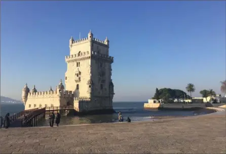  ?? PHOTOS BY BETH J. HARPAZ, THE ASSOCIATED PRESS ?? The Tower of Belem on the banks of the Tagus River in Lisbon, Portugal. The picturesqu­e fortress is a UNESCO World Heritage site and one of Lisbon’s most famous landmarks. It dates to the 16th century when Portuguese explorers sailed the globe.