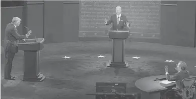  ?? RUTH FREMSON/THE NEW YORK TIMES ?? President Donald Trump, Joe Biden, and debate moderator Chris Wallace all gesture during the first scheduled presidenti­al debate Tuesday at Case Western Reserve University in Cleveland.