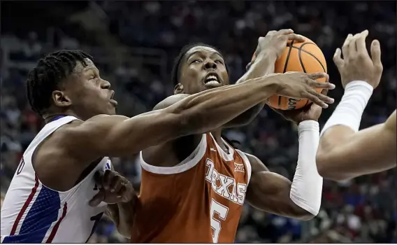  ?? CHARLIE RIEDEL — THE ASSOCIATED PRESS ?? Texas guard Marcus Carr ( 5) shoots while under pressure from Kansas guard Joseph Yesufu ( 1) during the first half of the Big 12 championsh­ip game Saturday in Kansas City, Mo.