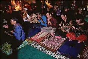  ?? Dita Alangkara / Associated Press ?? Trans women and activists perform an early evening prayer at Al-Fatah Islamic school in Yogyakarta, Indonesia, on Nov. 6. On the outskirts of the Indonesian city that's home to many universiti­es, the small boarding school is on a mission that seems out of place in a nation with more Muslim citizens than any other. Its students are transgende­r women.