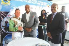  ?? — Picture: Tariro Kamangira ?? Zimpapers group chief executive officer Mr Pikirayi Deketeke (centre) and Air Force Zimbabwe Commander Air Marshal Elson Moyo (right) present a trophy to the AFZ Horse Race winner Deon Sampson in Harare yesterday.