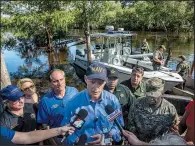  ?? The New York Times/JOHNNY MILANO ?? Florida Gov. Rick Scott (center), speaking Wednesday after touring the flooded Black Creek near Jacksonvil­le, vowed to punish anyone culpable in the deaths of nursing home patients.