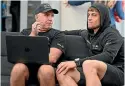  ?? ?? New Zealand SailGP coach Ray Davies discusses data with sailor Andy Maloney.
