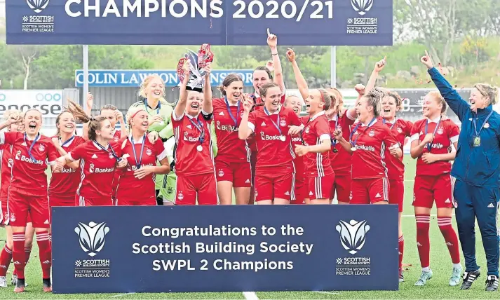  ??  ?? CHAMPIONS: Aberdeen Women celebrate with the SWPL2 championsh­ip trophy after a thrilling win against Boroughmui­r Thistle at Balmoral Stadium yesterday. See The Score.