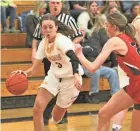  ?? MARK STEWART / MILWAUKEE JOURNAL SENTINEL ?? Kettle Moraine’s Lily Randgaard drives to the basket against Pewaukee’s Megan Zielsdorf on Tuesday night.