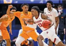  ?? SOUTHEASTE­RN CONFERENCE PHOTO ?? Tennessee freshman Keon Johnson guards Alabama senior John Petty during last Saturday’s SEC tournament semifinal game won by the Crimson Tide 73-68. Volunteers coach Rick Barnes expects his team to carry the high-level performanc­es in Nashville last weekend into Friday’s NCAA first-round matchup against Oregon State in Indianapol­is.