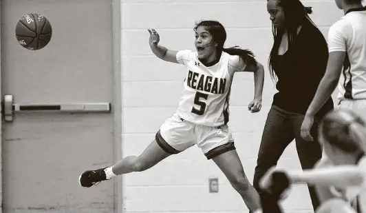  ?? Photos by Billy Calzada / Staff Photograph­er ?? Reagan guard Juliett Martinez, who scored 13 points and hit four 3-pointers, saves a ball from going out of bounds against Roosevelt on Wednesday.