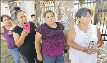  ?? Al Seib Los Angeles Times ?? RESIDENTS of the bungalows on Grand View Street listen at a news event staged by community activists, who said some displaced tenants may not be able to return if, for instance, their income levels disqualify them.