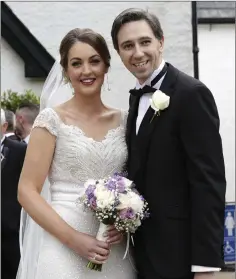  ??  ?? Newlyweds Caoimhe Wade and Simon Harris outside Kilquade Church last Friday.