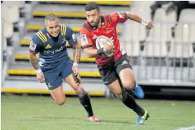  ?? Photo / AP ?? Richie Mo’unga runs around Highlander­s defender Aaron Smith to dot down for the Crusaders.