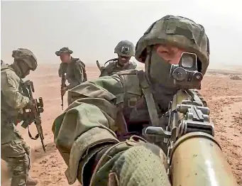  ?? AP ?? Russian and Tajik soldiers take part in joint war games at a firing range near Tajikistan’s border with Afghanista­n.