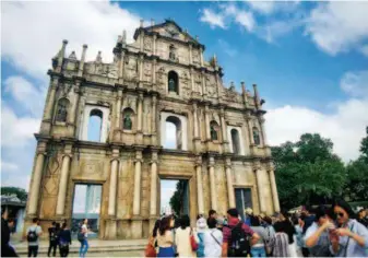  ??  ?? Tourists visit the Ruins of St. Paul's in Macao.