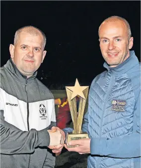 ?? ?? Pitch perfect Andy receives his Junior Sporting Club Hero award from Recognitio­n Express South East director David Mitchell