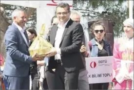  ??  ?? Prime Minister Tufan Erhurman was presented with a basket of local produce by Lapta Mayor Fuat Namsoy