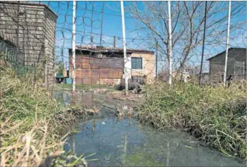  ??  ?? Stinky: Sewage flows through the yards of people’s homes (left) in Deneysvill­e and Refengkgos­to. Toilet paper, faeces, condoms and other items have jammed the sewage line