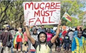  ?? BEN CURTIS/AP ?? Protesters in Harare, Zimbabwe, demand President Robert Mugabe step down Saturday.