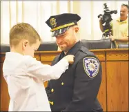  ?? Cassandra Day / Hearst Media Connecticu­t ?? Middletown Mayor Dan Drew, Police Chief William McKenna, City Hall employees, families and others attended Friday morning’s officer promotion ceremony in council chambers. Here, Profession­al Standards Division Sgt. Brian Hubbs is pinned by his son.