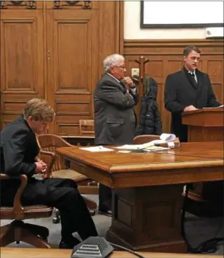  ?? TRACEY READ — THE NEWS-HERALD ?? Jason Harman hangs his head as his father, Jason Harman Sr., speaks Jan. 11 at his son’s sentencing in Lake County Common Pleas Court for a Madison Township shooting incident. Defense attorney Michael Peterson is in the middle.