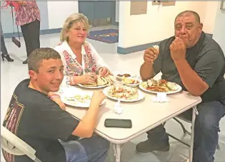  ??  ?? Our Lady of Lourdes School in Colusa hosted its 11th annual crab feed fundraiser on Friday to help support the operating costs of the private school. From left, Jesse, Christine and Christophe­r Rodriguez enjoy their crab.