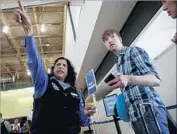  ??  ?? AN AIRSERV employee, Khamin Khan, helps a traveler find his way Friday at the airport.